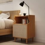 A natural ash finish solid wood bedside table featuring a tiered gallery shelf and one rattan door - Modera Furnish.