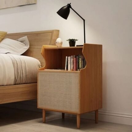 A natural ash finish solid wood bedside table featuring a tiered gallery shelf and one rattan door - Modera Furnish.