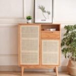 A natural ash finish solid wood sideboard featuring two rattan doors and one central storage drawer - Modera Furnish.
