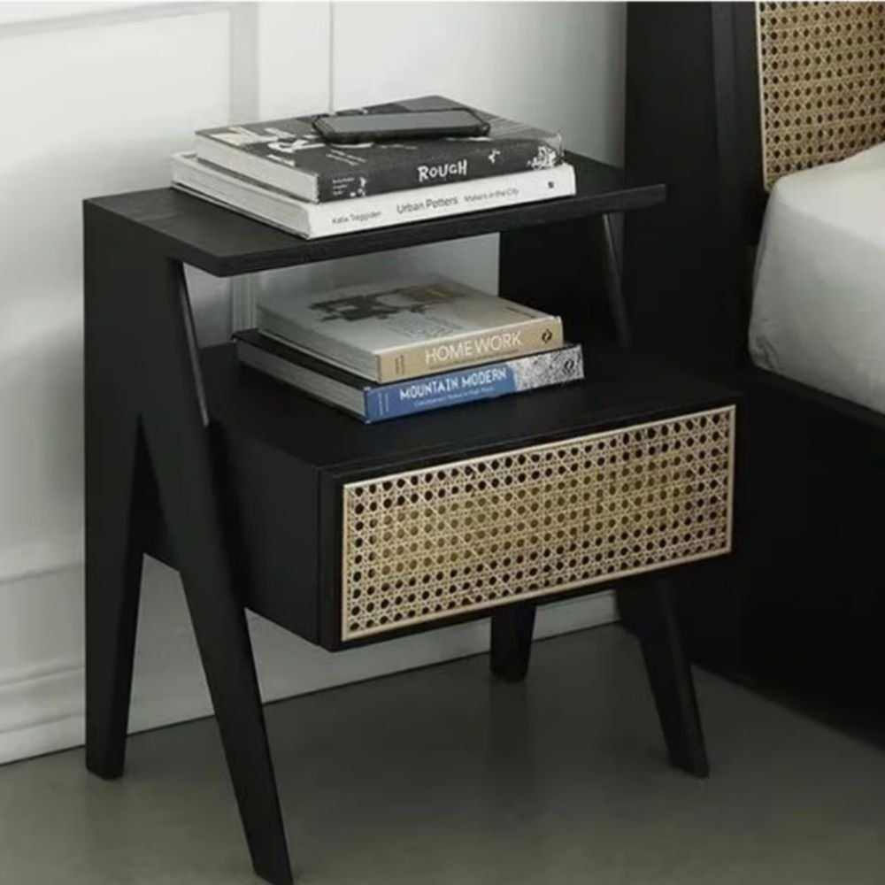 1 A black solid ash wood nightstand featuring a tiered shelf design and one drawer with a natural rattan panel - Modera Furnish.