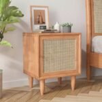 A warm honey solid acacia bedside table featuring a hand-woven cane door and tapered spindle legs - Modera Furnish.