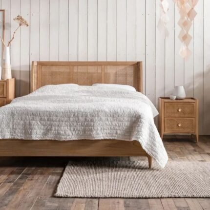 A natural light wood bed featuring a sophisticated three-panel wingback headboard with hand-woven cane inlays - Modera Furnish.