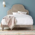 A sophisticated grey solid wood bed featuring a grand arched headboard with concentric architectural carvings - Modera Furnish.