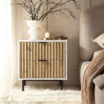 A contemporary white marble effect bedside table with two fluted oak drawers and black metal legs - Modera Furnish.