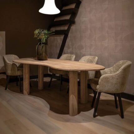 A natural teak wood dining table featuring a unique curved organic top and four thick cylindrical legs - Modera Furnish.