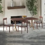 A set of two natural solid mango wood dining chairs with gray upholstered seats and tapered legs - Modera Furnish.