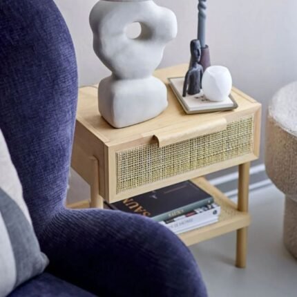 A natural solid wood side table featuring a hand-woven cane drawer and an open lower storage shelf - Modera Furnish.