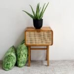 A natural solid wood end table featuring a hand-woven cane drawer front and a structured four-leg base - Modera Furnish.