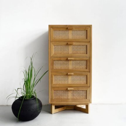 A natural vertical solid wood chest of drawers featuring five drawers with hand-woven cane panels and an X-frame base - Modera Furnish.