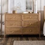 A natural rectangular solid wood chest of drawers featuring six drawers with hand-woven cane front panels - Modera Furnish.