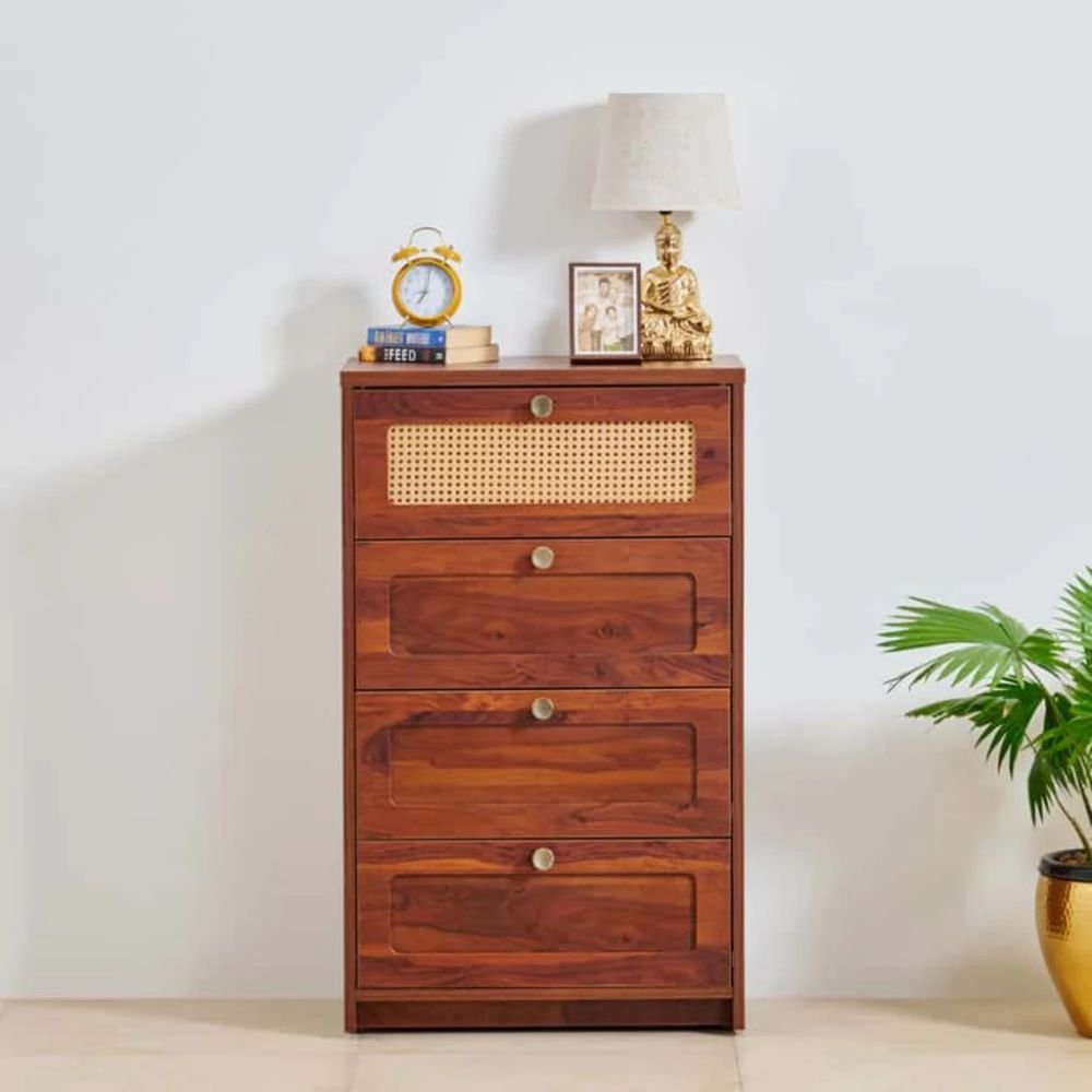 1 A brown solid wood chest of drawers featuring four storage drawers and a hand-woven cane top drawer detail - Modera Furnish.