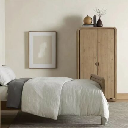 A natural solid mango wood wardrobe featuring a unique curved silhouette and two doors with inset semi-circular handles - Modera Furnish.