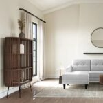 A brown solid wood bookshelf featuring a curved pill-shaped slatted design and three levels on black metal legs - Modera Furnish.