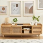 A natural solid wood TV cabinet with two cane doors and two drawers on gold-tipped legs - Modera Furnish.