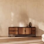 A natural solid wood and cane TV unit with four drawers and two doors on a black metal base - Modera Furnish.