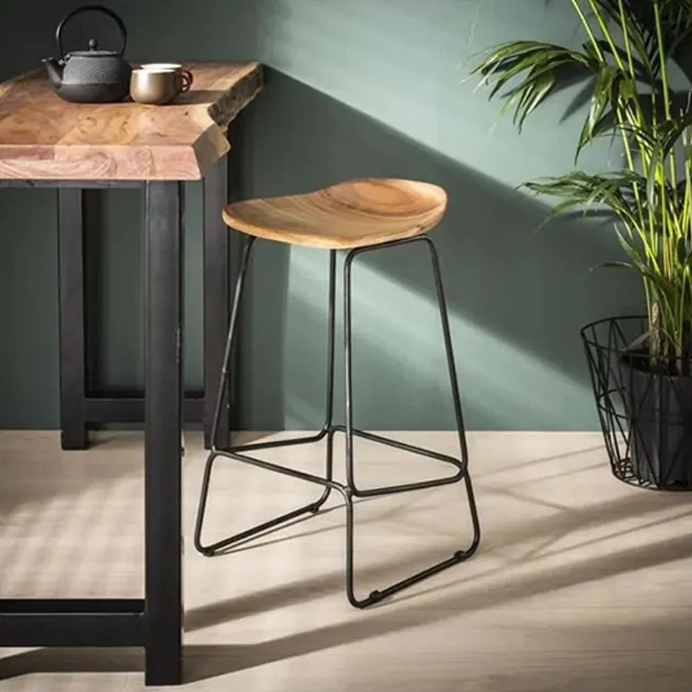 1 A natural solid mango wood bar stool with an ergonomic contoured seat and a black metal industrial frame - Modera Furnish.