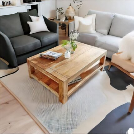 A natural finish solid acacia wood coffee table featuring a storage shelf and a minimalist 120 cm rectangular profile - Modera Furnish.
