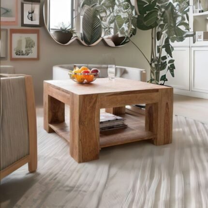 A natural finish solid wood square coffee table with block legs and a storage shelf - Modera Furnish.