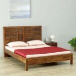 A provincial teak finish solid wood single bed featuring an arched headboard with artisanal floral carvings - Modera Furnish.