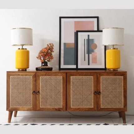 A long brown solid mango wood cabinet with four doors featuring hand-woven cane panels and circular metal pulls - Modera Furnish.