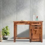 A sophisticated honey finish solid sheesham wood study desk featuring two storage drawers, a side cabinet, and artisanal geometric cut-outs - Modera Furnish.