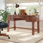A maple finish solid and engineered wood study table featuring five storage drawers and a rustic architectural silhouette - Modera Furnish.