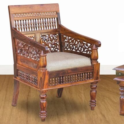 A brown hand-carved solid sheesham wood chair featuring intricate floral patterns and a natural jute cushioned seat - Modera Furnish.