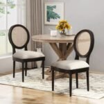 A dining chair set of two in black solid wood featuring an oval cane backrest and upholstered seats - Modera Furnish.