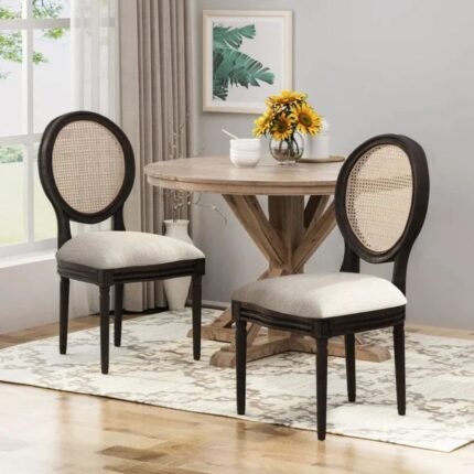 A dining chair set of two in black solid wood featuring an oval cane backrest and upholstered seats - Modera Furnish.