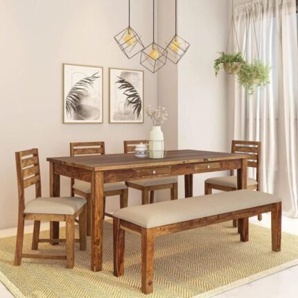 A brown six-seater solid sheesham wood dining set featuring a rectangular table with storage drawers, four chairs, and a cushioned bench - Modera Furnish.