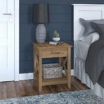A natural light wood solid wood nightstand featuring a single drawer with a black handle and an open storage shelf - Modera Furnish.