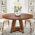 Solid wood round dining table with sculptural pedestal base in a warm brown finish for modern dining rooms – Modera Furnish