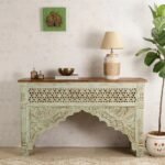 A sage green hand-carved solid mango wood console table with a floral lattice front and natural wood top - Modera Furnish.