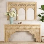 A beige hand-carved solid mango wood console table with traditional Indian scalloped arches and a distressed finish - Modera Furnish.