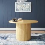 Round solid wood dining table with natural finish and fluted pedestal base in mid-century modern style – Modera Furnish.