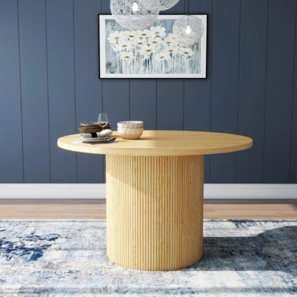 Round solid wood dining table with natural finish and fluted pedestal base in mid-century modern style – Modera Furnish.