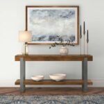 A long industrial-style brown solid wood console table with gunmetal gray metal frame legs styled in a modern entryway - Modera Furnish
