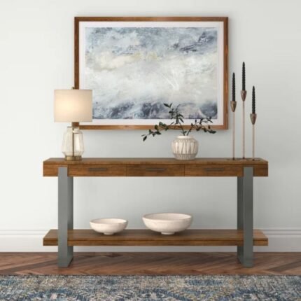 A long industrial-style brown solid wood console table with gunmetal gray metal frame legs styled in a modern entryway - Modera Furnish