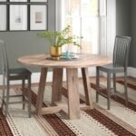 Solid wood round dining table with natural finish and contemporary base design - Modera Furnish