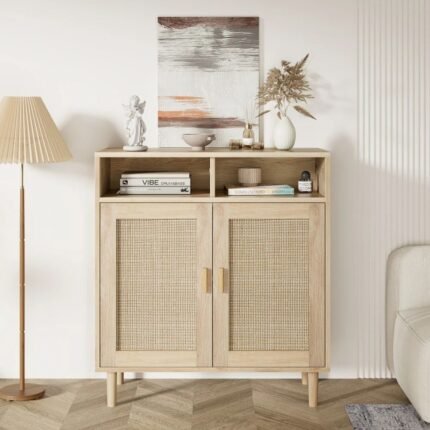 A natural light wood storage cabinet featuring two doors with woven cane panels, minimalist wood handles, and an open top shelving unit - Modera Furnish.