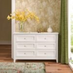 A white rectangular solid wood chest of drawers featuring a distressed finish and six spacious storage drawers - Modera Furnish.