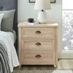 An off-white 3 drawer wood bedside table with a distressed finish and antique cup pull handles - Modera Furnish.