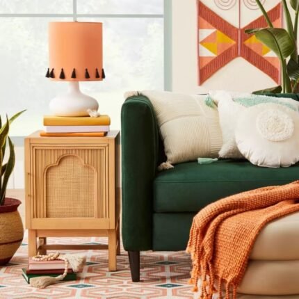 A natural finish solid wood bedside table featuring a single door with an arched rattan panel and gold hardware - Modera Furnish.