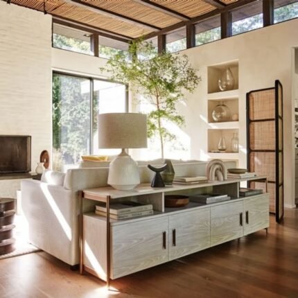 A winterwood finish solid wood media console table with four storage doors and light bronze steel accents - Modera Furnish.