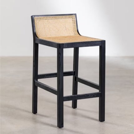 An obsidian black solid elm wood bar stool featuring a hand-woven rattan seat and back inlay - Modera Furnish.