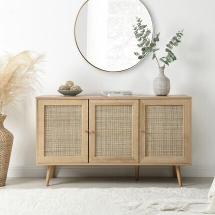A natural light wood sideboard featuring three hand-woven rattan doors and tapered legs - Modera Furnish.