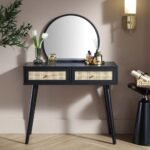 A black dressing table featuring two natural rattan drawers and a mounted circular mirror - Modera Furnish.