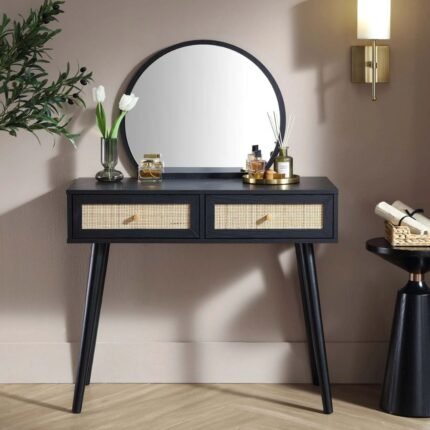 A black dressing table featuring two natural rattan drawers and a mounted circular mirror - Modera Furnish.