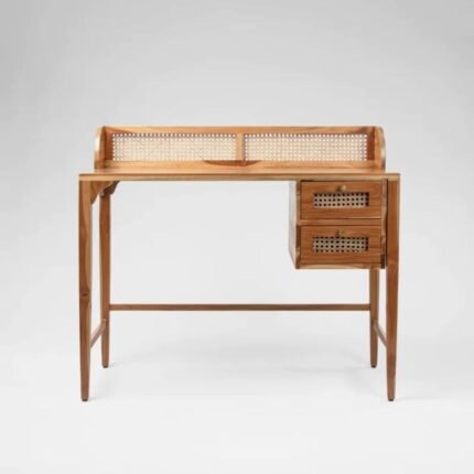 A natural teak solid wood study table with hand-woven cane drawer fronts and a raised back gallery - Modera Furnish.