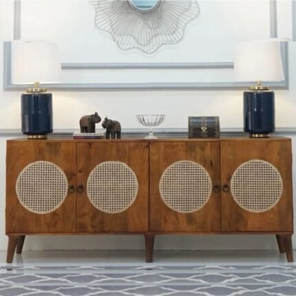 A natural finish solid mango wood sideboard cabinet with four doors featuring circular woven cane inserts - Modera Furnish.